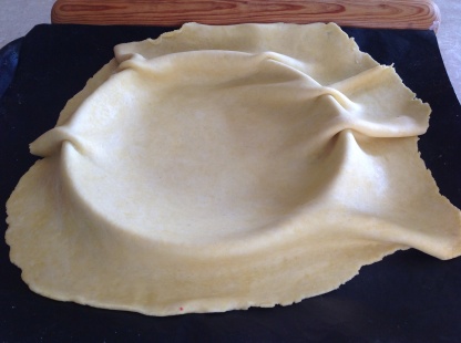 Pastry loosely draped over the tin
