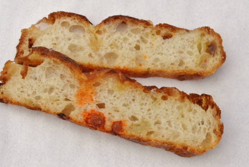 open crumb structure of roasted onion, chorizo & Parmesan focaccia